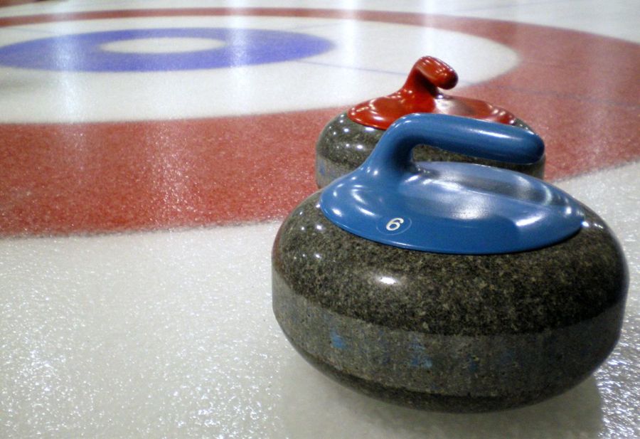 Curling_stones_on_rink_with_visible_pebble